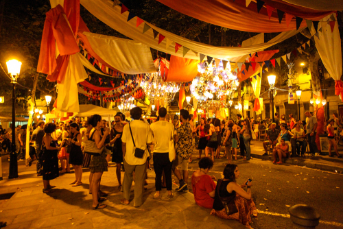 View of people in the Fiesta De Gracia celebration. Holiday in the neighbourhood Gracia in Catalan capital in August in Barcelona, Catalonia, Spain