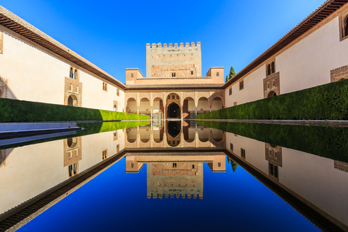 View of the Alhambra fortress and its beautiful pool and facade, Granada, Andalusia, Spain