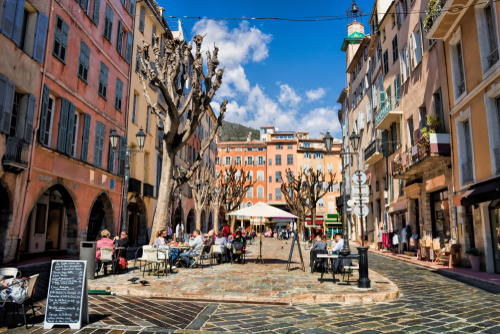 People enjoying the idyllic market square in Grasse in the French Riviera, Cote d'Azur, France