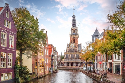 View of the beautiful Old city and its canal, Kaasmarkt in Alkmaar, The Netherlands, on a beautiful Sunny day
