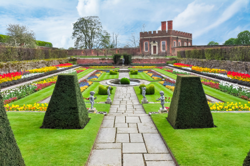Exterior view of Hampton Court Palace's colourful gardens in Richmond, London, United Kingdom
