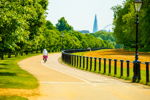Beautiful path in the Hyde park in London with a Shard skyscraper on the horizon, England, UK