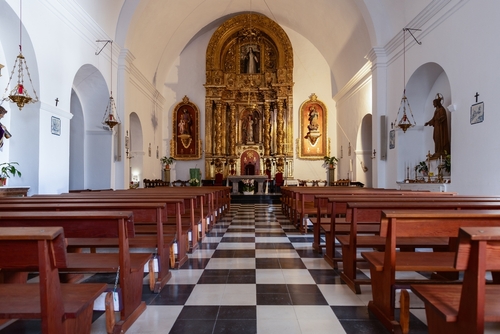 Inside the Puig de Missa church in Santa Eulalia, Ibiza Island, Balearic Islands, Spain, showcasing a stunning golden altar, complemented by traditional religious icons