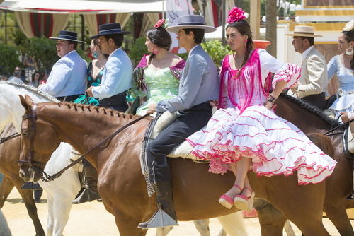 People mounted on horses and dressed in typical Andalusian costume, on fair ride in Jerez de la Frontera, Costa de la Luz, Cadiz, Andalusia, Spain