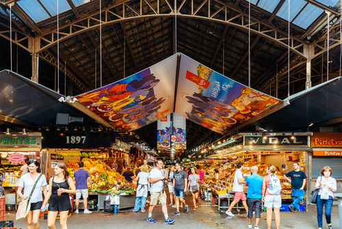 People In Barcelona Market (Mercat de Sant Josep de la Boqueria), a large public market and a tourist landmark with entrance from La Rambla street, Barcelona, Catalonia, Spain