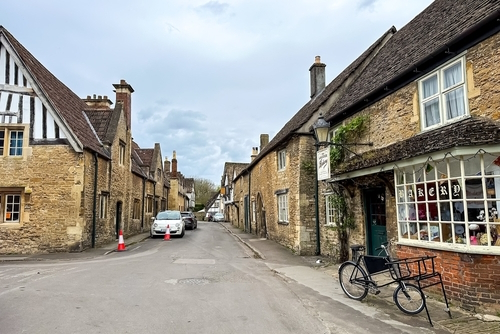 View of a street in the historic and well preserved village of Lacock, the Cotswolds, Gloucestershire, England, United Kingdom