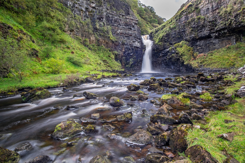 Lealt Falls, on the dramatic Isle Of Skye in scenic Scotland, UK, a fantastic adventure travel destination for a holiday vacation to view awesome picturesque scenery