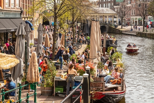 People sitting in a cafe on a beautiful day, city life in the center of the student city of Leiden, Holland