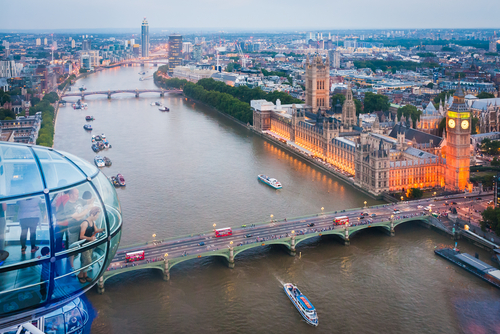 Tourists are enjoying London's skyline from a London Eye capsule. Also known as the Millennium Wheel, when erected in 1999 it was the world's tallest Ferris wheel, London, England, UK