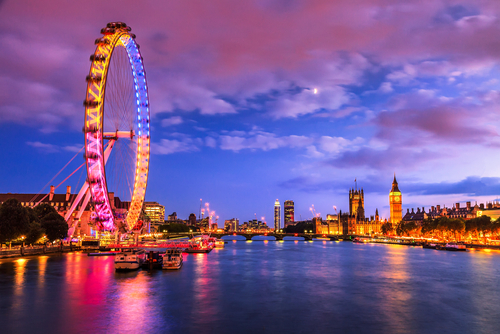 The beautiful glistering lights of the London Eye, County Hall, Westminster Bridge, Big Ben and Houses of Parliament in London, England, UK