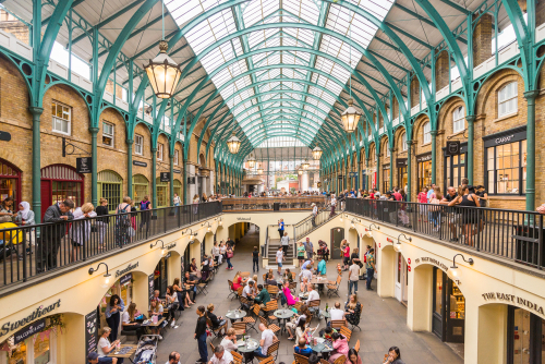 People sitting in a restaurant in Summer in Covent garden, one of the biggest flea market in London, England, United Kingdom
