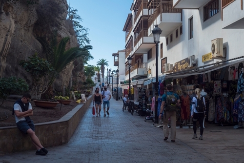 Pedestrian street full of tourist shops and apartments in the center of the resort town of Los Gigantes, Tenerife Island, The Canary Islands, Spain