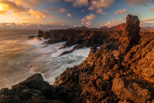 Beautiful sunset over the volcanic cliffs of Los Hervideros, Lanzarote Island, The Canary Islands, Spain