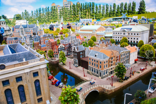 Visitors enjoying the replicas of famous dutch buildings as a tourist attraction in Madurodam miniature park open-air museum, The Hague, Holland