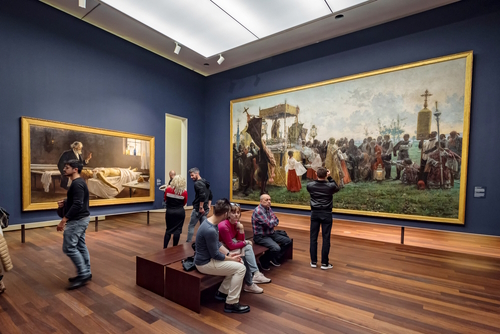 People enjoying archeological pieces in Palacio de la Aduana Museum of Malaga, Andalusia, Spain