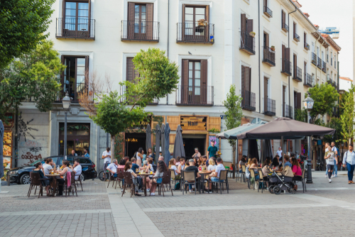 Santa Barbara Square in Malasaña, University District. traditional terrace and people gathering at sunset, Madrid, Spain