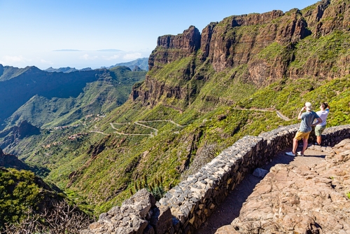 Two people look down on Masca village in Teno muntains, Tenerife Island, The Canary Islands, Spain