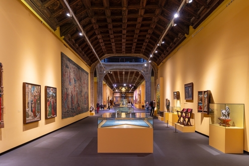 People admiring the works of art inside the Santa Cruz museum in Toledo, Castilla La Mancha, Spain