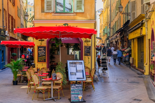 Tourists visit the pedestrian zone, commercial and cultural landmark with restaurants and shops in traditional houses. Nice, Cote d'Azur, France