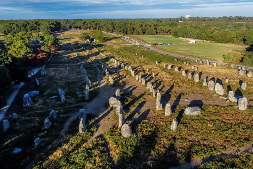 Aerial view of the Carnac stone alignments of Kermario in Morbihan, France - Prehistoric menhirs and megaliths in rows in Brittany