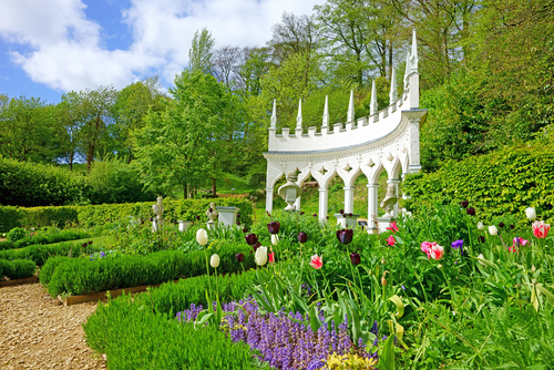 Tulips and a beautiful Spring late afternoon looking towards The Exedra in Rococo Garden, Painswick, The Cotswolds, Gloucestershire, United Kingdom