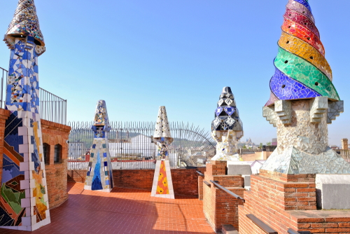 The Palau Guell, a distinctive modernist mansion built by Antoni Gaudi, the roof is decorated with curious chimneys covered in colorful mosaics in Barcelona, Catalonia, Spain