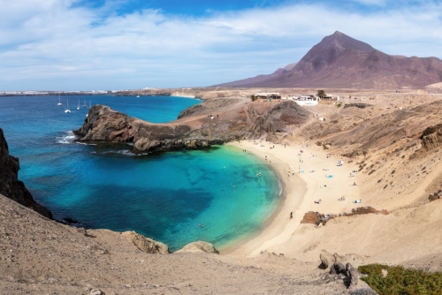 Aerial view of Playa de Papagayo beach, with blue emerald water and white sand, this is one of the most beautiful place in Lanzarote Island, Canary Islands, Spain