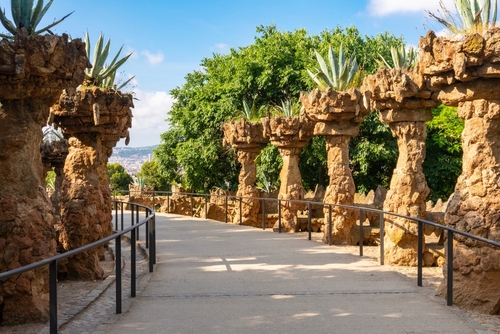 Pathway of shaped trees at the Parc Guell designed by Antoni Gaudi located on Carmel Hill, Barcelona, Catalonia, Spain
