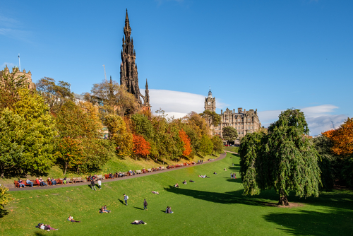 People enjoying the autumn sun in Edinburgh's famous 'Princess Street Gardens' in mid October, Scotland, UK