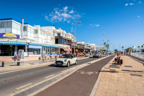 Avenida de las Playas street view with tourists in Puerto del Carmen, Lanzarote Island, The Canary Islands, Spain