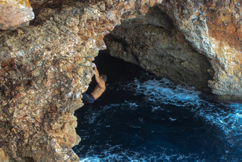 Man climbing without protection on rocks on cliff on Mallorca island, Balearic Islands, Spain