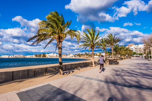 View of a person walking on the promenade in Roses in Costa Brava, Catalonia, Spain