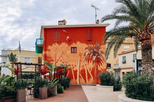 A beautiful building with a pattern on the facade, in the port area of Saint Jean Cap Ferrat in the French Riviera, Cote d'Azur, France