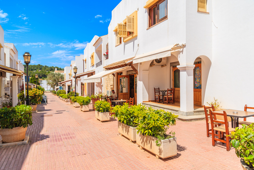 View of a street with typical architecture of Sant Carles de Peralta village with whitewashed houses, Ibiza island, Balearic Islands, Spain