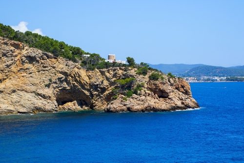 Punta de Sa Cova Blanca peninsula near Santa Eulària des Riu in the southeast of Ibiza island in the Balearic Islands, surmounted by the ruins of an ancient Genoese round tower, Spain