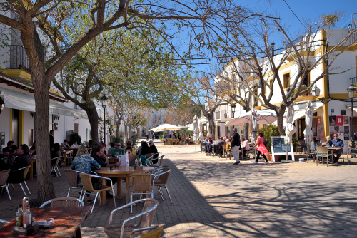 People sitting in restaurants at the historic center of Santa Gertrudis village on Ibiza Island, Balearic Islands, Spain