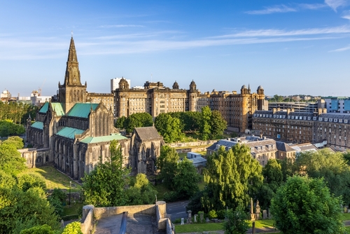 Glasgow Cathedral, the oldest cathedral on mainland Scotland, and the Old Royal Infirmary shot from the Necropolis Victorian Cemetery, Scotland, United Kingdom