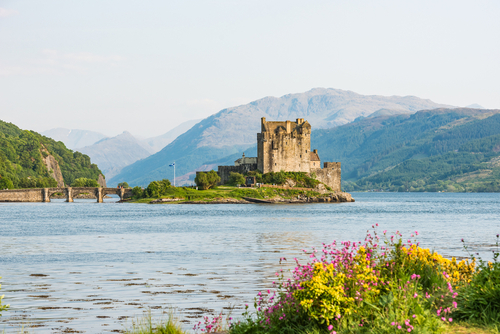 Eilean Donan Castle picture form the distance with sunset light at spring time, Isle of Skye, Scotland, UK