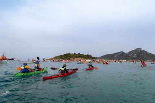 People participating in kayak and SUP race around the Dragonera island on Mallorca Island, Balearic Islands, Spain