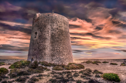 Dramatic view of the Ses Portes tower in Ses Salines Natural Park on Ibiza Island, Balearic Islands, Spain