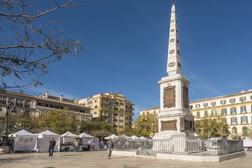 Market stalls in the Merced Square with the Torrijos Monument in Malaga, Andalusia, Spain