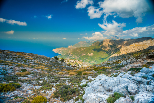Beautiful landscape view of rocky mountains and clouds, Tramuntana mountains with blue sea in background, on the western part of Mallorca island, Balearic Islands, Spain
