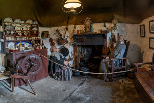 Interior view of the kitchen ands hearth with fireplace inside a typical Scottish Highlands cottage, Kilmuir, Island of Skye, Scotland, UK