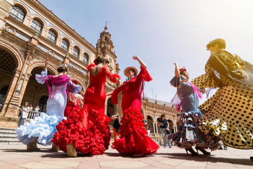 Young women dance flamenco on Plaza de Espana in Seville, Andalusia, Spain