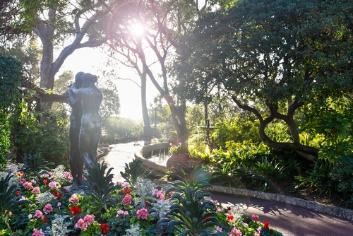 Backlight view with sun beams of the St Martin Gardens, opened in 1816, with Mediterranean and exotic plants and the sculpture 