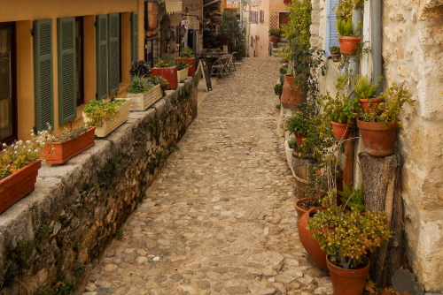 View of a narrow cobblestone, romantic street in the medieval village of Saint Agnes, The French Riviera, Cote d'Azur, France