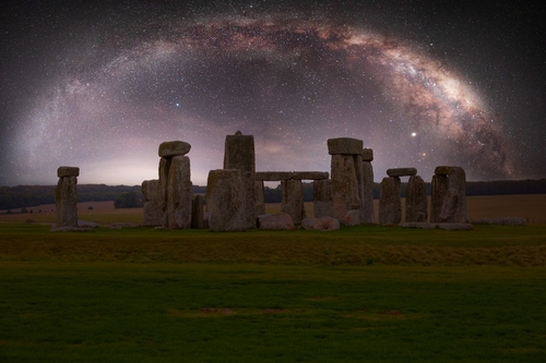 View of Stonehenge at night with the milky way galaxy in the background. This is a historic site with a ring of standing stones, it was believed to be a burial site, located west of Amesbury in England, United Kingdom