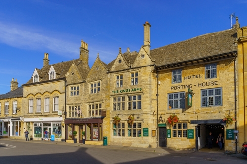 Street view with various buildings, locals, and visitors, in Stow-on-the-Wold, the Cotswolds region, England, United Kingdom