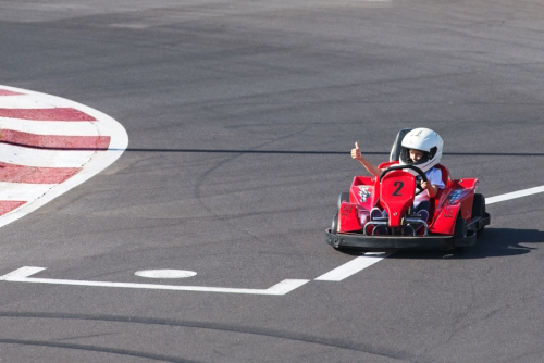 Child in helmet driving karting on track in San Sebastian, Tenerife island, The Canaries, Spain