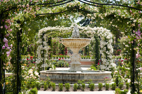 A fountain decorated with flowers at the Buen Retiro Park, one of the largest parks of the city of Madrid, Spain